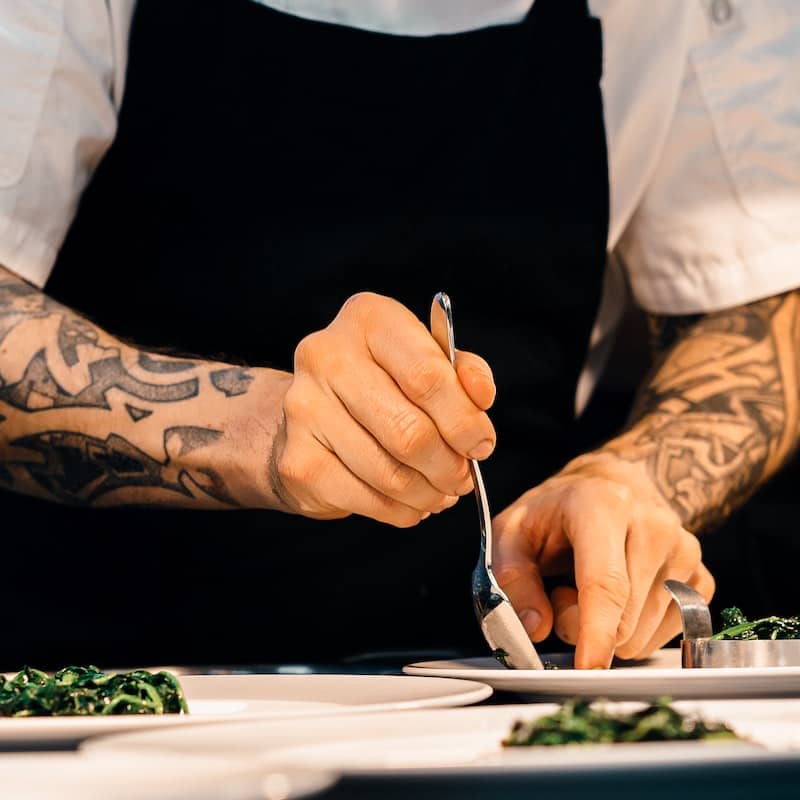 Photo of a chef plating a meal
